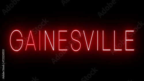 Flickering red retro style neon sign glowing against a black background for GAINESVILLE