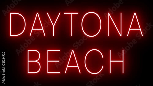 Flickering red retro style neon sign glowing against a black background for DAYTONA BEACH photo