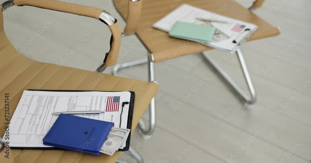 Visa application form and pen on empty chairs. Immigration to USA Visa application form and pen on empty chairs. Immigration to USA