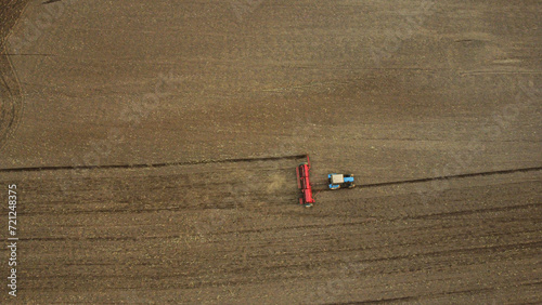 Aerial view with drone of tractor plowing the land in the countryside