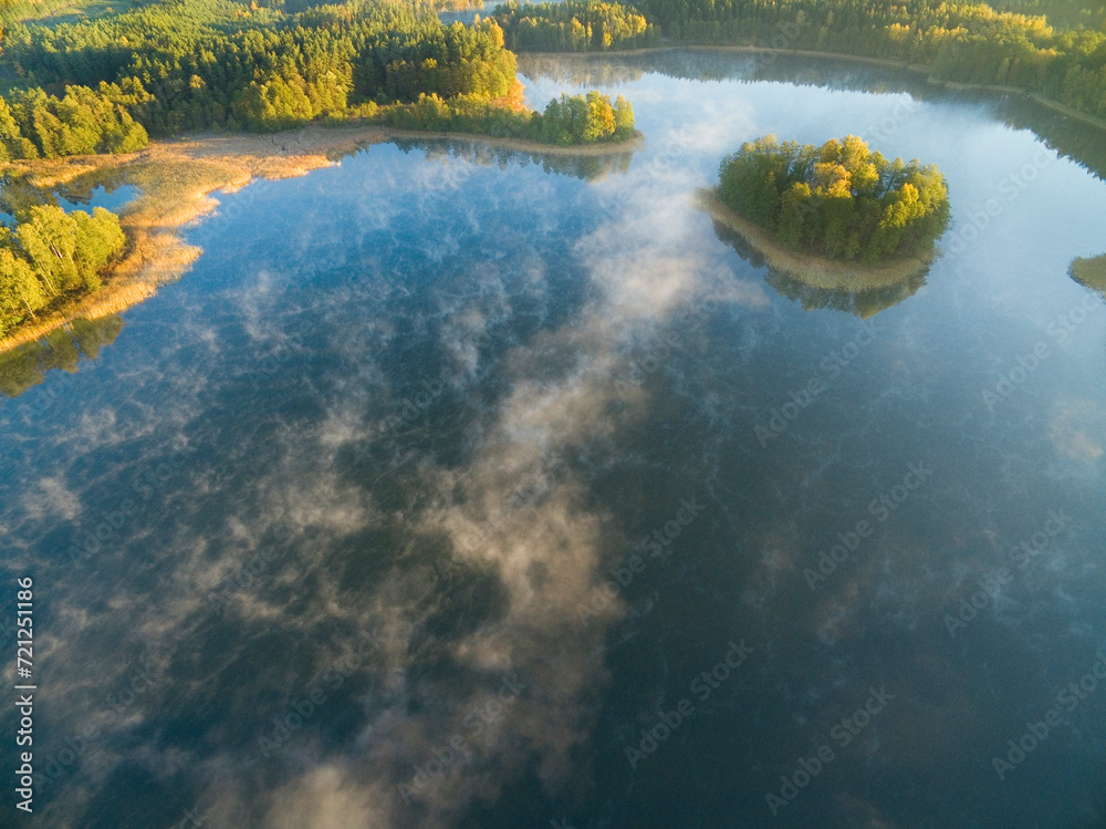Aerial view of Heart Eater Island on Krzywa Kuta lake in autumn colors, Mazury, Poland