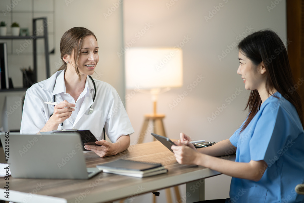 Female doctor sitting at work looking at the history of patients in the clinic or in the hospital Female doctor sitting at work looking at the history of patients in the clinic or in the hospital