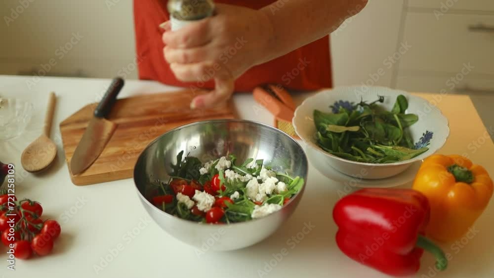 Close up of woman cooking and adding spice to meal, laughing and spending time in the kitchen. High quality FullHD footage Close up of woman cooking and adding spice to meal, laughing and spending time in the kitchen. High quality FullHD footage