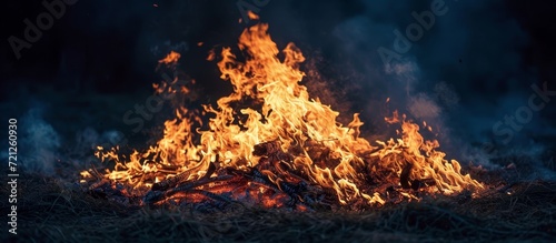 Captivating Night Fire: Engulfed in a Fiery Blaze, the Night Succumbs to the Intense Heat of a Fire that Burns Passionately Through the Darkness