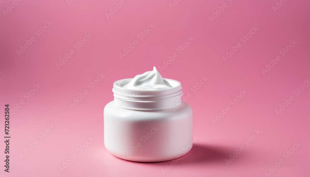 A white bottle of lotion on a pink background A white bottle of lotion on a pink background