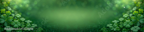 Wide green banner with lots of three-leaf clover shamrocks for St Patricks Day celebration and copy space