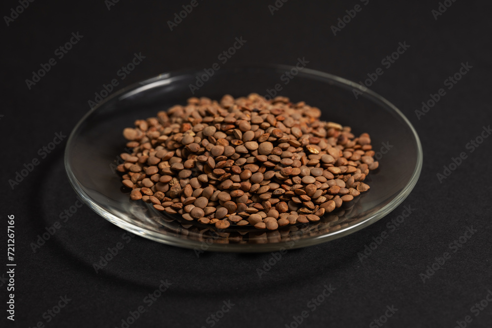 Lentils in bowl on dark background Lentils in bowl on dark background