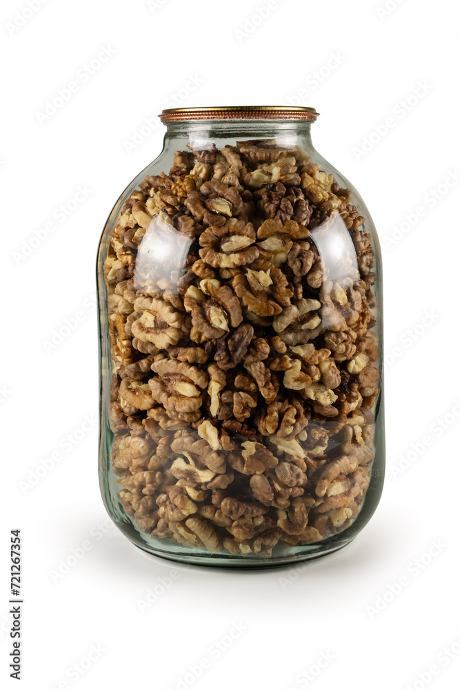 The walnut kernels in jar isolated on white background. The walnut kernels in jar isolated on white background.