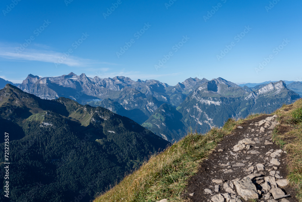 View of a hiking path in the mountains of  inner switzerland on a sunny day in autumn 