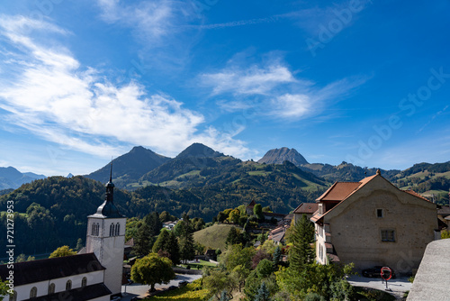 View of the city of Gruyere in Switzerland and the surrounding mountains on a sunny day 
