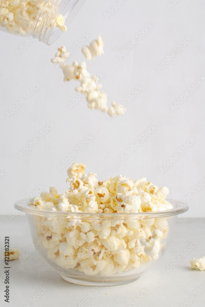 Popcorn in a glass bowl, isolated on white background. Popcorn in a glass bowl, isolated on white background.