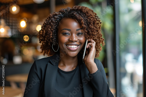 Portrait of a smiling black female entrepreneur talking on the phone 
