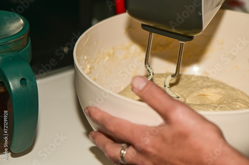 woman kneading dough with a mixer in the kitchen 2