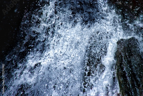 Detail of water splash of a waterfall in wild forest © Daniel