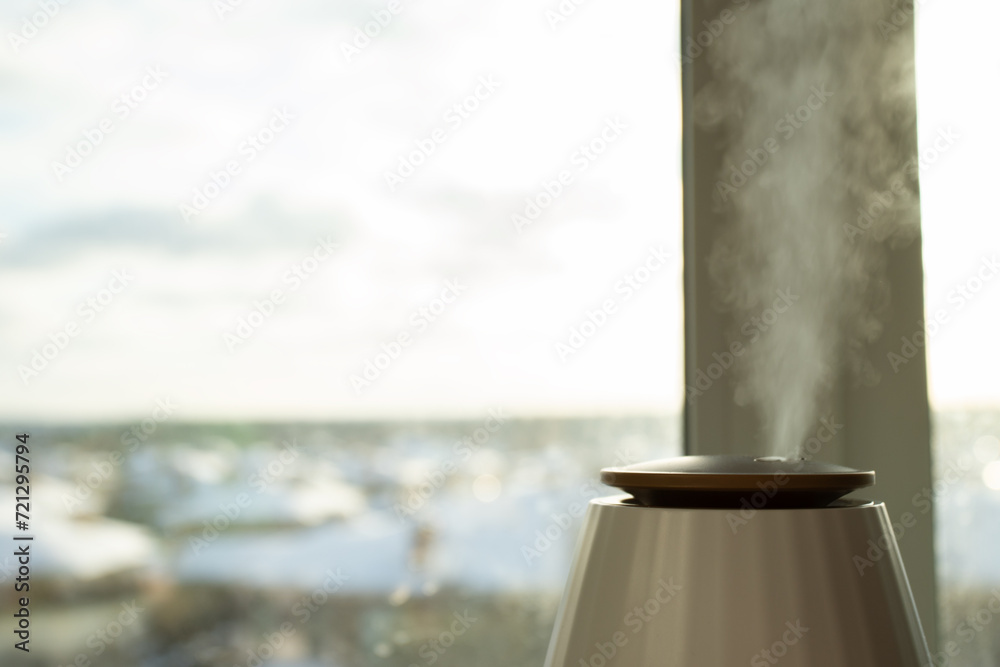 Humidify the air, window backdrop, diffuser in action, modern home technology Humidify the air, window backdrop, diffuser in action, modern home technology
