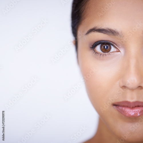 Half portrait, beauty and space with woman in studio on white background for natural skincare. Face, eye and aesthetic with confident young indian model on mockup for skin wellness or cosmetics