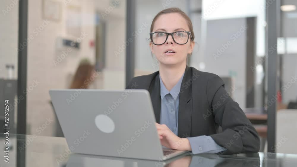 Businesswoman Shocked at Camera while at Work