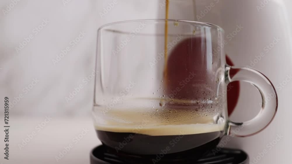 Capsule coffee machine in action, pouring espresso into a cup, coffee barista, hot beverage Capsule coffee machine in action, pouring espresso into a cup, coffee barista, hot beverage