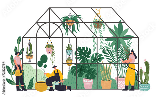 People working in planting greenhouse, glass orangery, botanical garden greenhouse