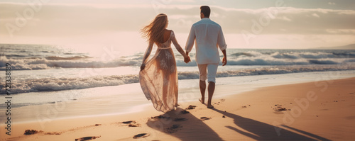 Happy young couple on the beach, enjoying their time together on the vacation. Active lifestyle concept photo