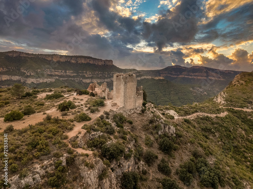 Dramatic aerial sunset view of Chirel castle medieval ruin with square towers above the Jucar river in Spain