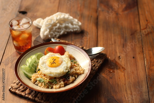 Fried Rice or Nasi Goreng with cucumber, tomato and agg. Selective focus