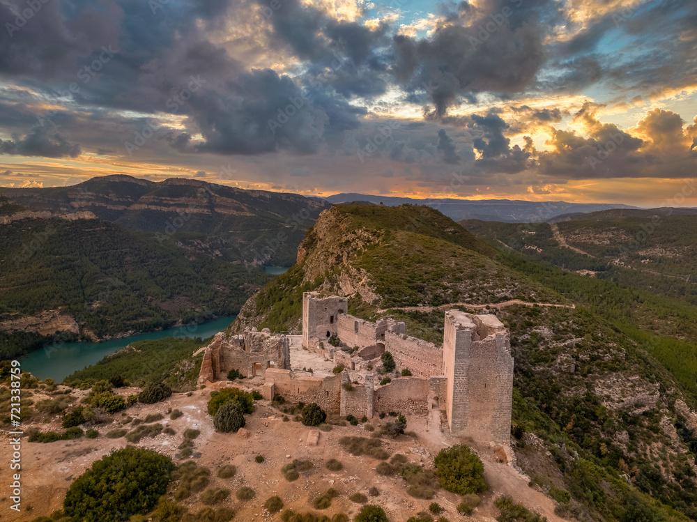 Dramatic aerial sunset view of Chirel castle medieval ruin with square towers above the Jucar river in Spain