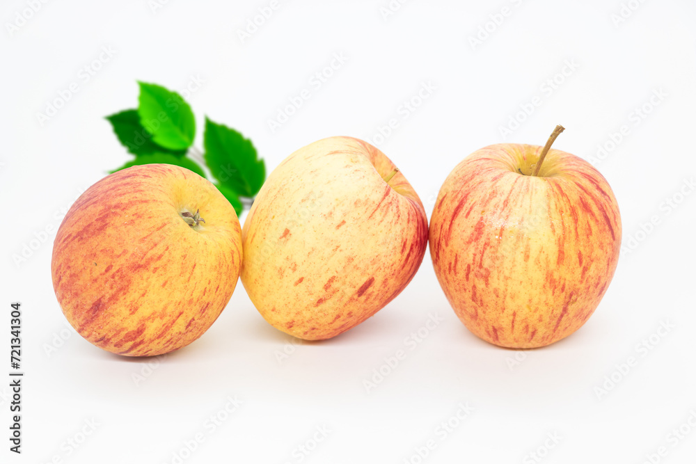 Whole apple with leaves isolated on white background with clipping path and full depth of field. Whole apple with leaves isolated on white background with clipping path and full depth of field.