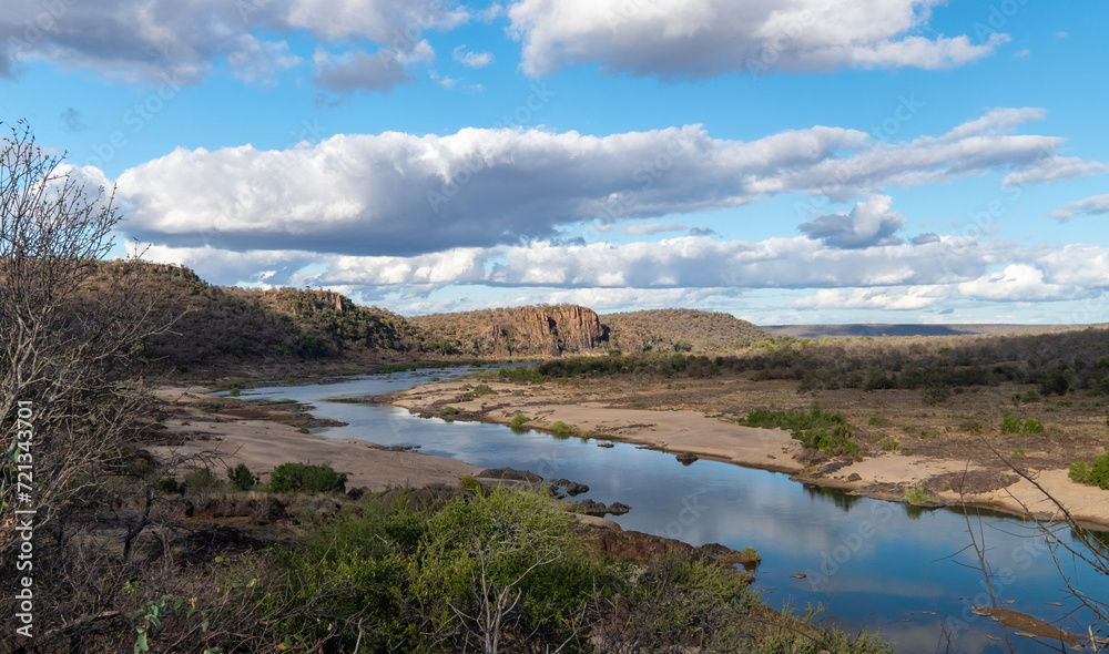 Olifants river, Kruger National Park, slowly winding its way toward a rocky outcrop of hills than rise up from the river bank. 