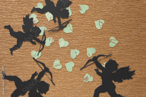 traditional crafting cupid silhouettes and scrapbooking paper hearts on metallic gold crepe paper