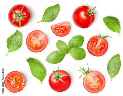 Cherry tomatoes and basil leaves on a white isolated background, top view