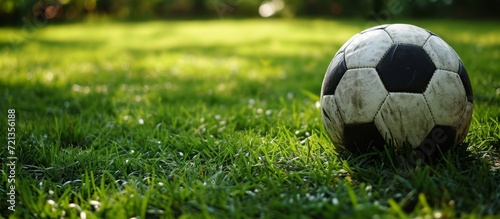 Football and Ball on the Green Grass - A Stunning Display of Football, Ball, Green, and Grass in Perfect Harmony.