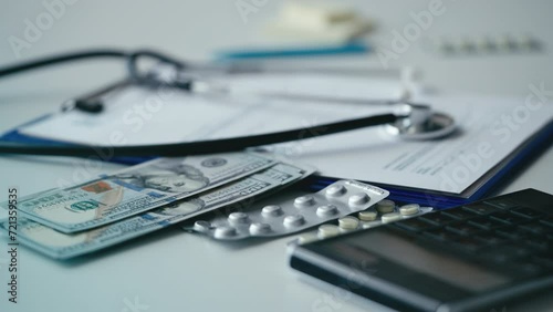 Detail shot of medical forms, money and stethoscope, U.S. healthcare system photo