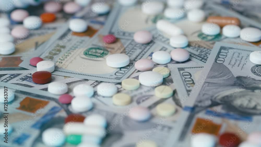 Colorful pills lying on dollar banknotes, pharmaceutical industry, medicine Colorful pills lying on dollar banknotes, pharmaceutical industry, medicine