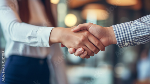 Professional handshake in a casual setting, demonstrating a friendly and approachable business style.