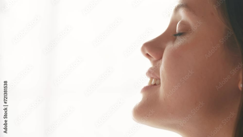 girl on a white background looks to the side. beauty dream concept. woman closes her eyes she dreams. lifestyle the girl smiles, shows her teeth, she thinks about her wonderful future girl on a white background looks to the side. beauty dream concept. woman closes her eyes she dreams. lifestyle the girl smiles, shows her teeth, she thinks about her wonderful future