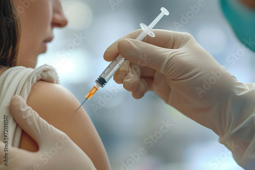 Close-up of a beautiful woman receiving Covid-19 vaccine for immunization against coronavirus by a doctor in a hospital. Concept of healthcare and disease prevention for elderly people. ?oronavirus photo