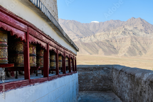 prayer wheels at tibetan monastery entrance