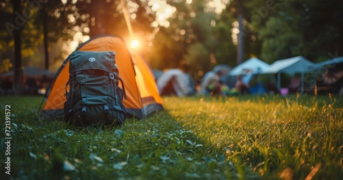 A Serene Camping Setup with Tent, Backpack, and Gear on a Lush Green Lawn