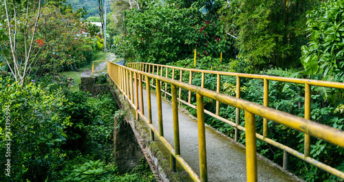 Yellow bridge with metal bars through jungle in El Valle de Anton in Panama