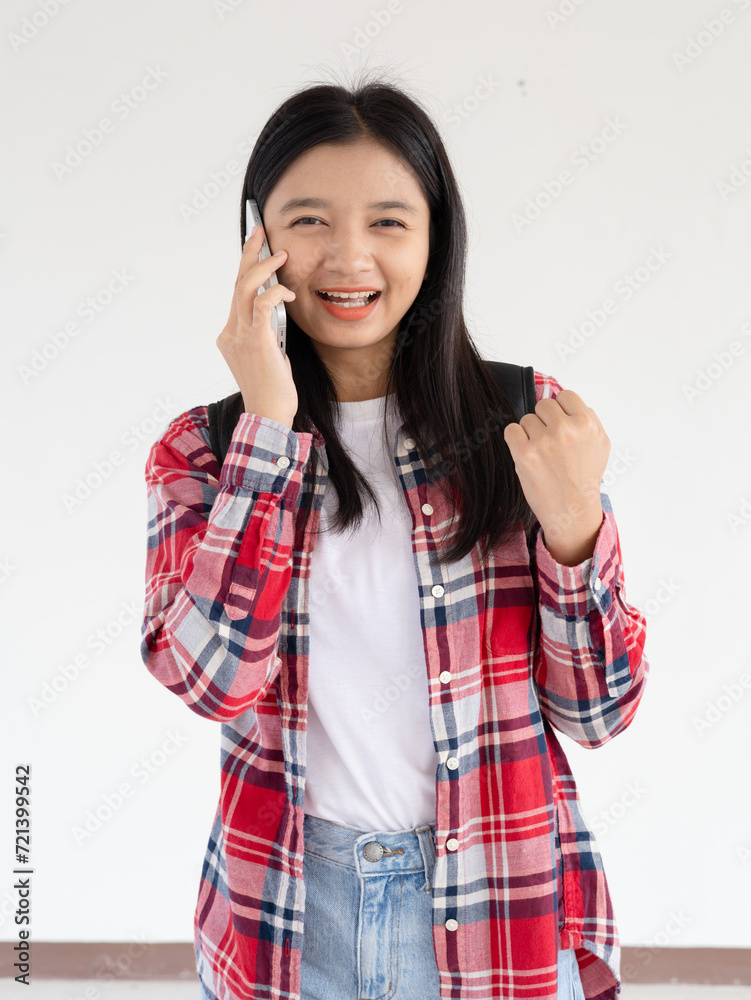 Asian young girl using smartphone at school. Asian young girl using smartphone at school.