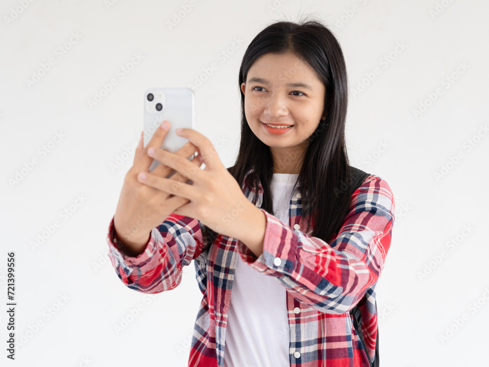 Asian young girl using smartphone at school. Asian young girl using smartphone at school.