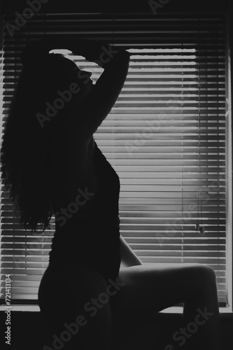Silhouette of a woman in a window.
