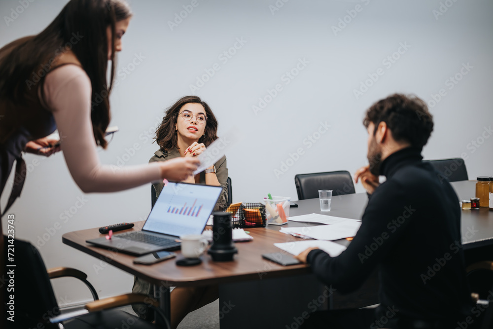 A focused group of professionals analyze data during a business meeting, exchanging ideas and strategizing for success. A focused group of professionals analyze data during a business meeting, exchanging ideas and strategizing for success.