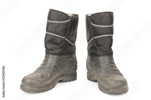 Dirty insulated old boots on a white background. Hiking boots.
