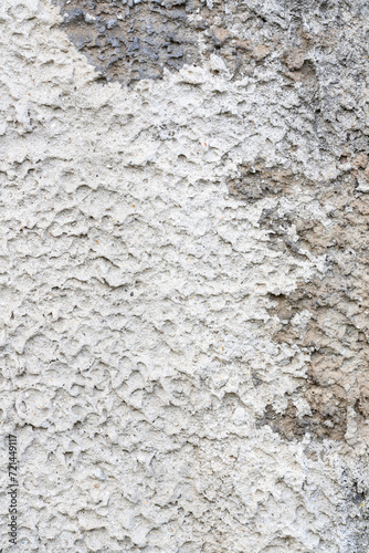 Rough gray plaster on the outer wall of the palace.