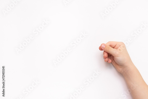 Hand of little child with shadow on white background holding or giving something like blank card, photo, piece of paper or postcard. Banner or mockup with copy space photo