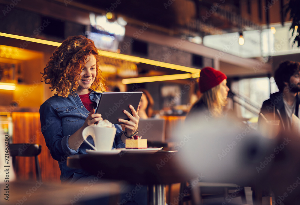Young woman using tablet in cafe Young woman using tablet in cafe
