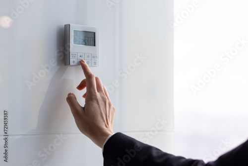 The air conditioning and heating control panel for the apartment and office is located on a white wall.