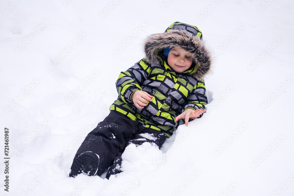 little child playing in the snow in winter little child playing in the snow in winter